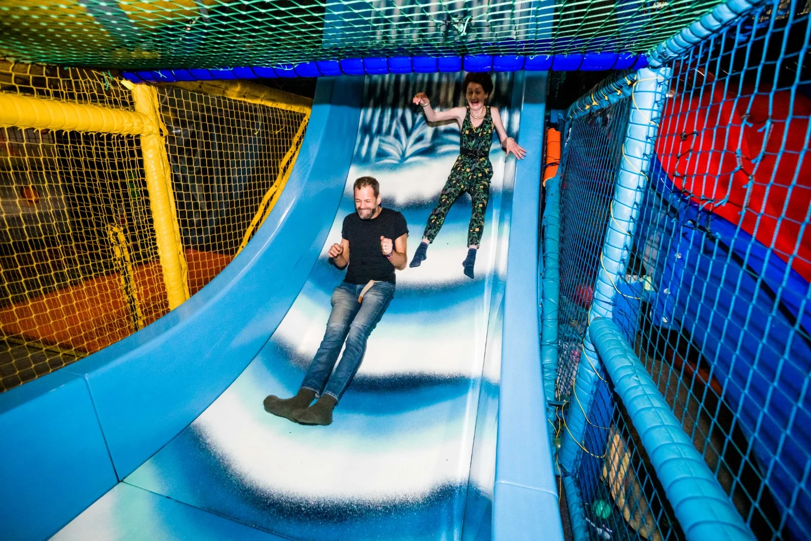 Adults racing down the giant slide